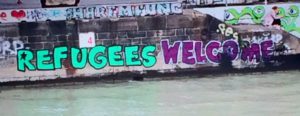 Graffiti along the Danube reads "refugees welcome."