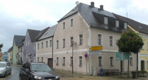 A sign outside of my grandparent's old house points to the Flossenbürg memorial. 